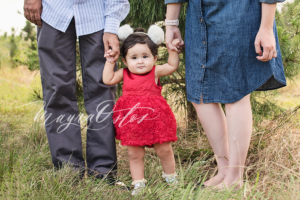 Mom and Dad Holding Standing Toddler